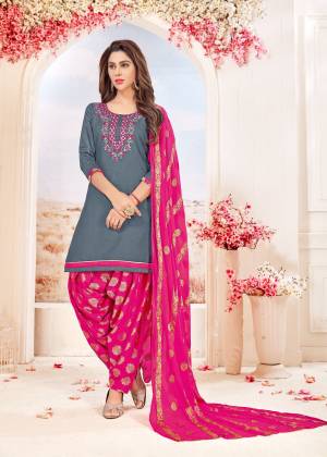 Here Is A Pretty Combination In Dress Material In Grey Colored Top Paired With Contrasting Dark Pink Colored Bottom And Dupatta. Its Top And Bottom Are Cotton Based Paired With Chiffon Dupatta. Buy This Dress Material Now.