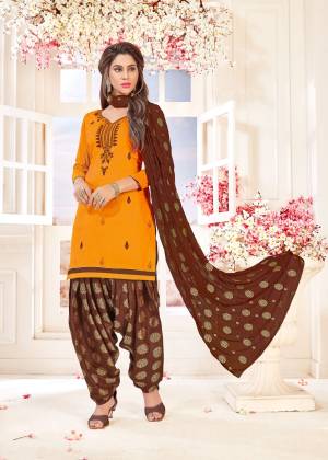 Beat The Heat With This Bright Orange Colored DREss Material Paired With Contrasting Brown Colored Bottom And Dupatta. Its Top And Bottom Are Cotton Based Paired With Chiffon Jacquard Dupatta. 