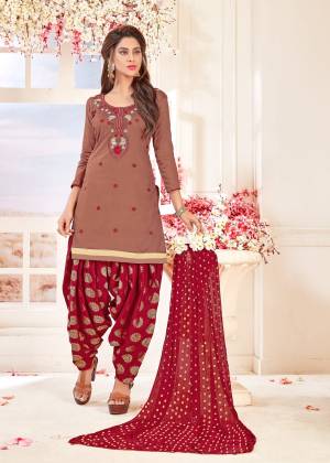 You Will Definitely Earn Lots Of Compliments Wearing This Suit In Light Brown Colored Top Paired With Maroon Colored Bottom And Dupatta. This Dress Material Is Cotton Based Paired With Chiffon Dupatta .