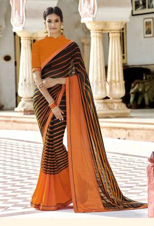 Grab This Elegant Looking Saree In Black And Orange Color Paired With Orange Colored Blouse. This Saree Is Georgette Based Beautified With Lining Prints. 