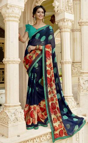 Here Is An Attractive Looking Saree In Navy Blue Color Paired With Aqua Blue Colored Blouse. This Saree And Blouse Are Georgette Fabricated Beautified With Bold Polka Prints. Buy This Saree Now.