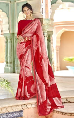 Look Pretty Draping This Lovely Saree In Pink And Red Color Paired With Red Colored Blouse. This Saree And Blouse Are Georgette Fabricated Beautified With Prints All Over. 