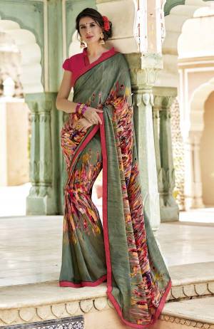 Add This New Shade To Your Wardrobe With This Pretty Saree In Olive Green Color Paired With Contrasting Dark Pink Colored Blouse. This Saree And Blouse Are Georgette Based Beautified With Prints All Over. 