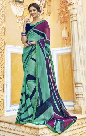 Here Is An Attractive Looking Saree In Sea Green Color Paired With Navy Blue Colored Blouse. This Saree And Blouse Are Georgette Fabricated Beautified With Bold Polka Prints. Buy This Saree Now.