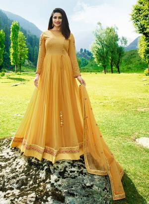 Celebrate this Festive Season Wearing This Heavy Designer Floor Length Suit In Yellow Color Paired With Yellow Colored Bottom And Dupatta. Its Top Is Fabricated On Georgette Paired With Santoon Bottom And Chiffon Dupatta. It Has Heavy Embroidery Over Its Yoke Which Is Making The Suit More Attractive. 