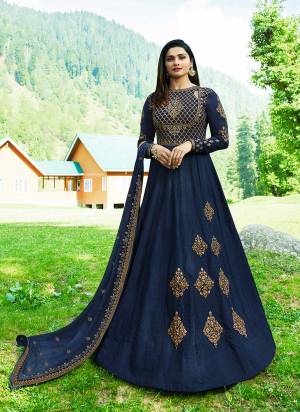 Enhance Your Personality Wearing This Heavy Deisgner Floor Length Suit In Navy Blue Color Paired With Navy Blue Colored Bottom And Dupatta. Its Top Is Fabricated On Silk Beautified With Heavy Embrodiery. This Designer Piece Will Give An Unique Look From The Crowd.
