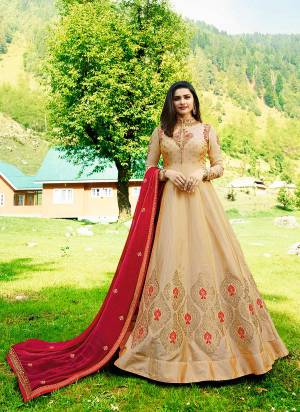 Simple And Elegant Looking Designer Floor Length Suit Is Here In Beige Color Paired With Beige Colored Bottom And Contrasting Red Dupatta. Its Top Is Fabricated On Silk Paired With Santoon Bottom And Chiffon Dupatta. Buy Now.