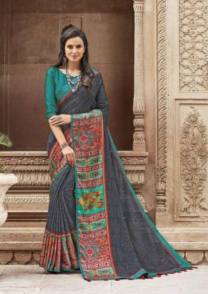 You Will Definitely Earn Lots Of Compliments Wearing This Designer Saree In Dark Grey Color Paired With Teal Blue Colored Blouse. This Saree Is Linen Fabricated Paired With Satin Blouse. Buy This Saree Now.