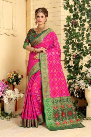 Look Attractive In This Silk Based Saree In Rani Pink Color Paired With Contrasting Dark Green Colored Blouse. This Saree Is Fabricated On Jacquard Silk Paired With Art Silk Blouse. It Is Beautified With Weave All Over.