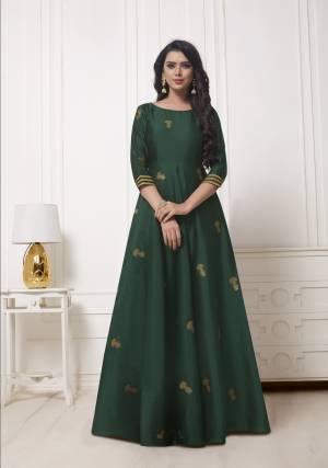 Celebrate This Festive Season With This Pretty Looking Designer Floor Length Suit In Pine Green Color .It Is Fabricated On Satin Jacquard With Weaved Motifs All Over. Buy Now.