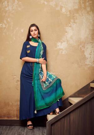 Here Is A Beautiful Readymade Long Kurti In Dark Blue Color Paired With Teal Blue Colored Scarf. This Kurti IS Rayon Fabricated Paired With Cotton Muslin Scarf. This Printed Scarf Adds A Very Rich Look To It.