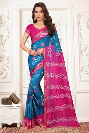 Look Pretty In This Blue  And Pink Colored Saree Paired With Pink Colored Blouse. This Saree Is Tafeta Silk Based Paired With Art Silk Fabricated Blouse. It Is Beautified With Bandhani Prints All Over.