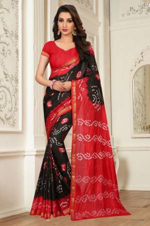 Grab This Attractive Looking Saree For A Bold And Beautiful Look With This Black And Red Color Paired With Red Colored Blouse. This Saree Is Tafeta Silk Based Paired With Art Silk Fabricated Blouse. It Has Very Pretty Bandhani Prints All Over It.