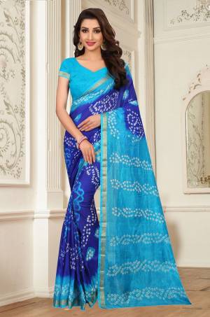 Go With The Shades Of Blue With This Bandhani Printed Saree In Royal Blue And Turquoise Blue Color Paired With Turquoise Blue Colored Blouse. This Silk Base Saree Will Give A Rich Look Like Never Before.