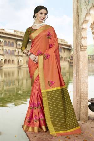 A Must Have Shade In Every Womens Wardrobe Is Here With this Peach Colored Saree Paired With Contrasting Olive Green Colored Blouse. This Saree Is Fabricated On Satin Silk Paired With Art Silk Blouse. 