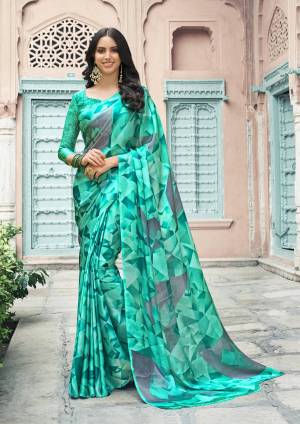 Here Is A Beautiful Shade In Green With This Saree In Sea Green Color Paired With Sea Green Colored Blouse. This Saree And Blouse Are Satin Georgette Based Beautified With Multiple Prints all Over It. Buy Now.