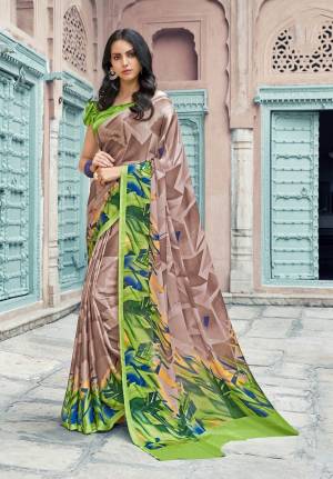 Go With Prints This Season Wearing This Attractive Beige Colored Saree Paired With Green Colored Blouse. This Saree And Blouse are Satin Georgette Based Beautified With Multi Prints All Over IT.