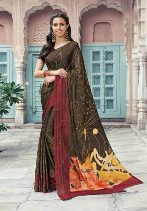 For A Bold and Beautiful Look, Grab This Designer Printed Saree In Dark Brown Color Paired With Dark Brown Colored Blouse. This Saree And Blouse Are Fabricated On Satin Georgette Beautified With Prints All Over It. Buy This Saree Now.