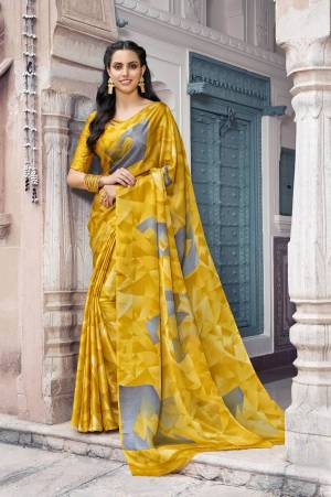 Celebrate This Festive Season Wearing This Printed Saree In Yellow Color Paired With Yellow Colored Blouse. This Saree And Blouse Are Satin Georgette Based Beautified With Prints All Over. 