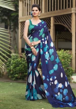 Here Is A Beautiful Shade In Blue With This Saree In Navy Blue  Color Paired With Sea Green Colored Blouse. This Saree And Blouse Are Satin Georgette Based Beautified With Multiple Prints all Over It. Buy Now.