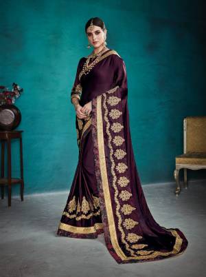 Add This Lovely Shade To Your Wardrobe With this Heavy Designer Saree In Wine Color Paired With Wine Colored Blouse. This Saree Is Fabricated On Satin Silk Paired With Art Silk Fabricated Blouse. It Is Beautified With Heavy Jari And Stone Work.