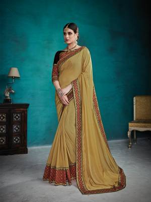 Celebrate This Festive Season Wearing This Designer Saree In Light Yellow Color Paired With Contrasting Brown Colored Blouse. This Saree And Blouse are Silk Based Which Gives A Rich Look To Your Personality. Buy Now.