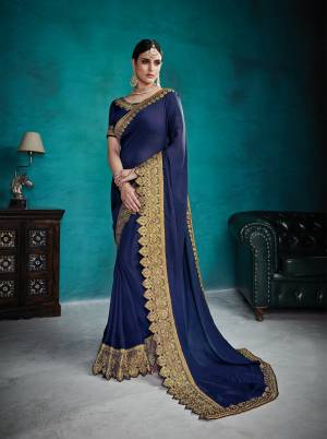 Enhance Your Personality Wearing This Designer And Rich Look Saree In Navy Blue Color Paired With Navy Blue Colored Blouse. This Saree Is Silk Georgette Based Paired With Art Silk Fabricated Blouse. It Is Beautified With Heavy Embroidered Lace Border Making The Saree Attractive.