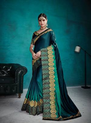 You Will Definitely Earn Lots Of Compliments Wearing This Designer Saree In Dark Teal Blue Shade Paired With Matching Blouse. This Saree Is Fabricated On Satin Silk Paired With Art Silk Fabricated Blouse. It Is Beautified With Heavy Embroidered Lace Border And Blouse. Buy This Designer Saree Now.