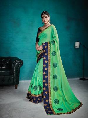 Celebrate This Festive Season Wearing This Designer Saree In Green Color Paired With Contrasting Navy Blue Colored Blouse. This Saree And Blouse are Silk Based Which Gives A Rich Look To Your Personality. Buy Now.