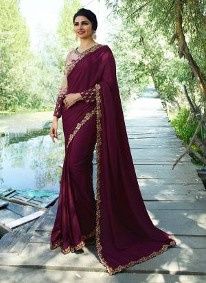 Add This New Shade To Your Wardrobe With This Designer Saree In Wine Color Paired With Cream And Wine Colored Blouse. This Saree Is Soft Silk Based Paired With Printed Blouse. It IS Beautified With Floral Prints And Attractive Embroidery.