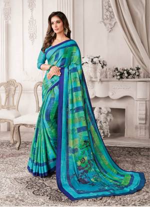 For Your Casual Or Semi-Casual Wear, Grab This Saree In Blue Color Paired With Blue Colored Blouse. This Saree And Blouse Are Georgette Based Beautified With Prints All Over It.