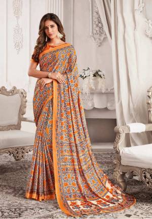 Grab This Beautiful Orange And Grey Colored Saree Paired With Orange Colored Blouse. This Saree And Blouse Are Georgette Based Beautified With Floral Prints All Over It. Buy Now.