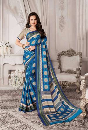 Add This Checkered Printed Saree To Your Wardrobe In Blue Color Paired With Blue Colored Blouse. This Saree And Blouse Are Georgette Based Beautified With Checks Prints All Over It.