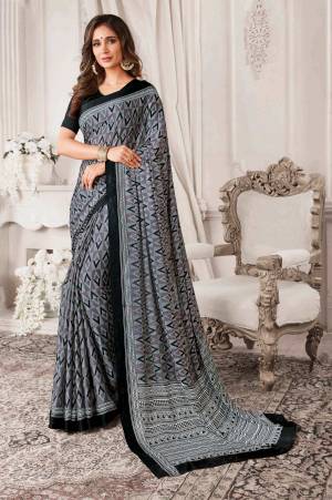 Flaunt Your Rich and Elegant Taste Wearing This Printed Saree In Grey Color Paired With Black Colored Blouse. This Saree And Blouse Are Georgette Based With Geometric Prints.