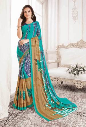 For Your Casual Or Semi-Casual Wear, Grab This Saree In Blue Color Paired With Navy Blue Colored Blouse. This Saree And Blouse Are Georgette Based Beautified With Prints All Over It.