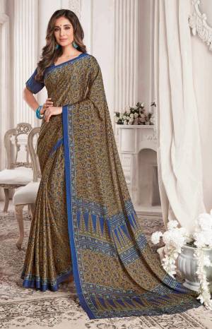 Darkest Color In Green Is Here With This Pretty Printed Saree In Military Green Color Paired With Dark Blue Colored Blouse. This Saree And Blouse Are Georgette Based Beautified With Floral Prints all Over.