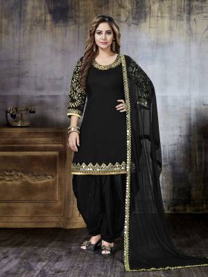 Grab This Beautiful Salwar Suit For A Bold and Beautiful Look In Black Color. Its Top Is Fabricated On Art Silk Paired With Santoon Bottom And Net Dupatta. It Is Beautified With Heavy Jari Embroidery And Mirror Work.