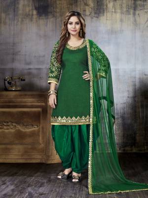 Celebrate This Festive Season With Beauty And Comfort Wearing This Designer Salwar Suit In Green Color Paired With Green Colored Bottom And Dupatta. Its Top Is Fabricated On Art Silk Paired With Santoon Bottom And Net Dupatta. Buy This Semi-Stitched Suit Now.