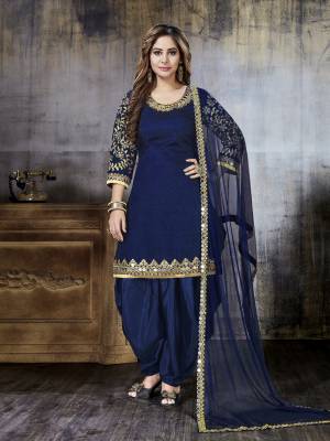 Grab This Beautiful Salwar Suit For A Bold and Beautiful Look In Royal Blue Color. Its Top Is Fabricated On Art Silk Paired With Santoon Bottom And Net Dupatta. It Is Beautified With Heavy Jari Embroidery And Mirror Work.