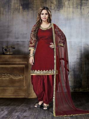 Celebrate This Festive Season With Beauty And Comfort Wearing This Designer Salwar Suit In Maroon Color Paired With Maroon Colored Bottom And Dupatta. Its Top Is Fabricated On Art Silk Paired With Santoon Bottom And Net Dupatta. Buy This Semi-Stitched Suit Now.