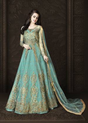 Get Ready For The Upcoming Festive Season with This Designer Floor Length Suit In Turquoise Blue Color Paired With Turquoise Blue Colored Bottom And Dupatta.Its Top And Dupatta Are Net Based Paired With Art Silk Bottom. 