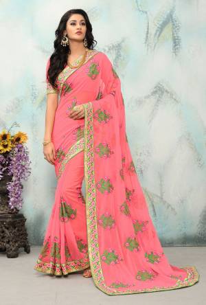 Look Pretty In This Georgette Based Pink Colored Saree Paired With Pink colored Blouse. It Is Beautufied With Contrasting Floral Embroidery All Over It. 