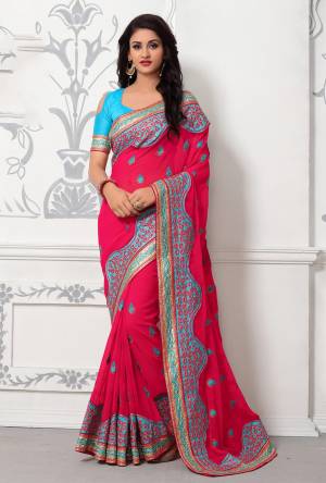 Bright And Visually Appealing Color Is Here With This Designer Saree In Rani Pink Color Paired With Contrasting Turquoise Blue Colored Blouse. This Saree Is Georgette Paired With Art Silk Fabricated Blouse. It Is Beautified With Resham embroidery Over The Saree And Lace Border.