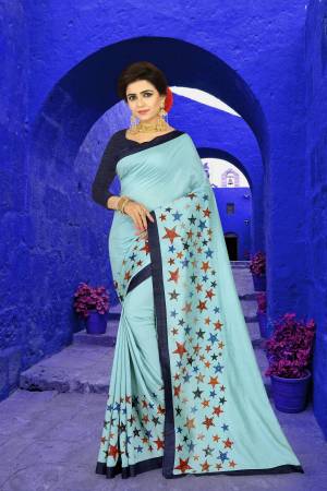 Add This Lovely Saree To Your Wardrobe For Semi-Casuals Or Festive Wear, Grab This Designer Saree In Aqua Blue Color  Paired With Navy Blue Colored Blouse. This Saree Is Beautified With Prints And Stone Work. 