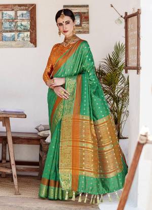 Grab This Beautiful Green Colored Silk Saree Paired With Contrasting Rust Orange Colored Blouse. This Saree Is Fabricated On Nylon Silk Paired With Brocade Fabricated Blouse. It Is Beautified With Weave All Over.