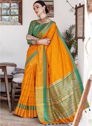 Celebrate This Festive Season Wearing This Rich Looking Saree In Musturd Yellow Color Paired With Contrasting Green Colored Blouse. This Saree Is Nylon Silk Based Paired With Brocade Fabricated Blouse. 