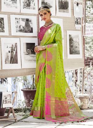 Look Attractive Wearing This Nylon silk Based Saree In Light Green Color Paired With Contrasting Rani Pink Colored Blouse. This Saree And Blouse Are Beautified With Weave Making It More Attractive.