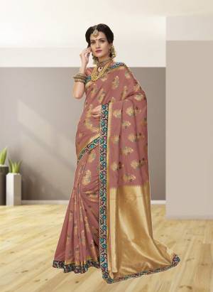 Add This Very Beautiful And Unique Color To Your Wardrobe Wearing This Saree In Dusty Pink Color Paired With Dusty Pink Colored Blouse. This Saree And Blouse Are Fabricated On Jacquard Silk With Very Beautifully Combined Weaving And Embroidery. Buy Now.