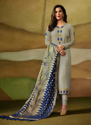 Flaunt Your Rich And Elegant Taste Wearing This Designer Straight Cut Suit In Light Grey Color Paired With Contrasting Royal Blue Colored Dupatta. Its Top Is Fabricated On Satin Georgette Paired With Santoon Bottom Bansarasi Silk Dupatta. Buy Now.