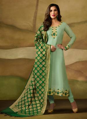 This Season Is About Subtle Shades And Pastel Play, So Grab This Designer Straight Cut Suit In Pastel Green Color Paired With Green Colored Dupatta. Its Top Is Satin Georgette Based Paired With Santoon Bottom And Banarasi Silk Dupatta. Buy Now.